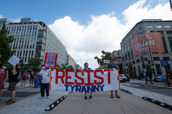 Free DC rally held August 11, 2025, to oppose Trump’s planned federal takeover of DC. Marchers are carrying a banner that says "Resist Tyranny"; they are walking past the LIUNA building which bears a banner that says "It's Better in a Union."