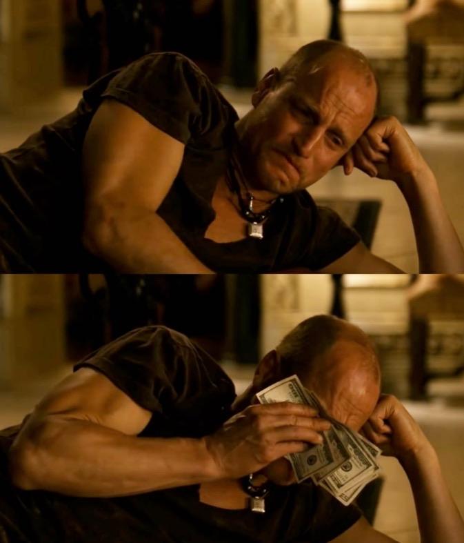 Two frames from the 2009 film Zombieland. In the first frame we see Tallahassee (portrayed by actor Woody Harrelson) with a sad face, clearly crying. In the second frame, Tallahassee wipes his tears with dollar bills.