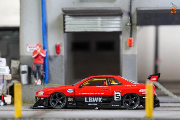 A focus shot on Nissan Skyline LB-ER34 Super Silhouette by Mini GT in 1:64 scale with 1:64 figure on AREA 164