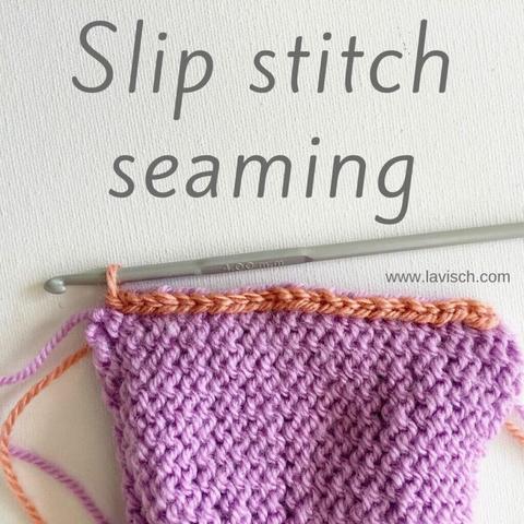 The wrong sides of 2 pieces of knitting in lilac yarn, have been seamed together using slip stitch with salmon pink yarn, and a crochet hook.