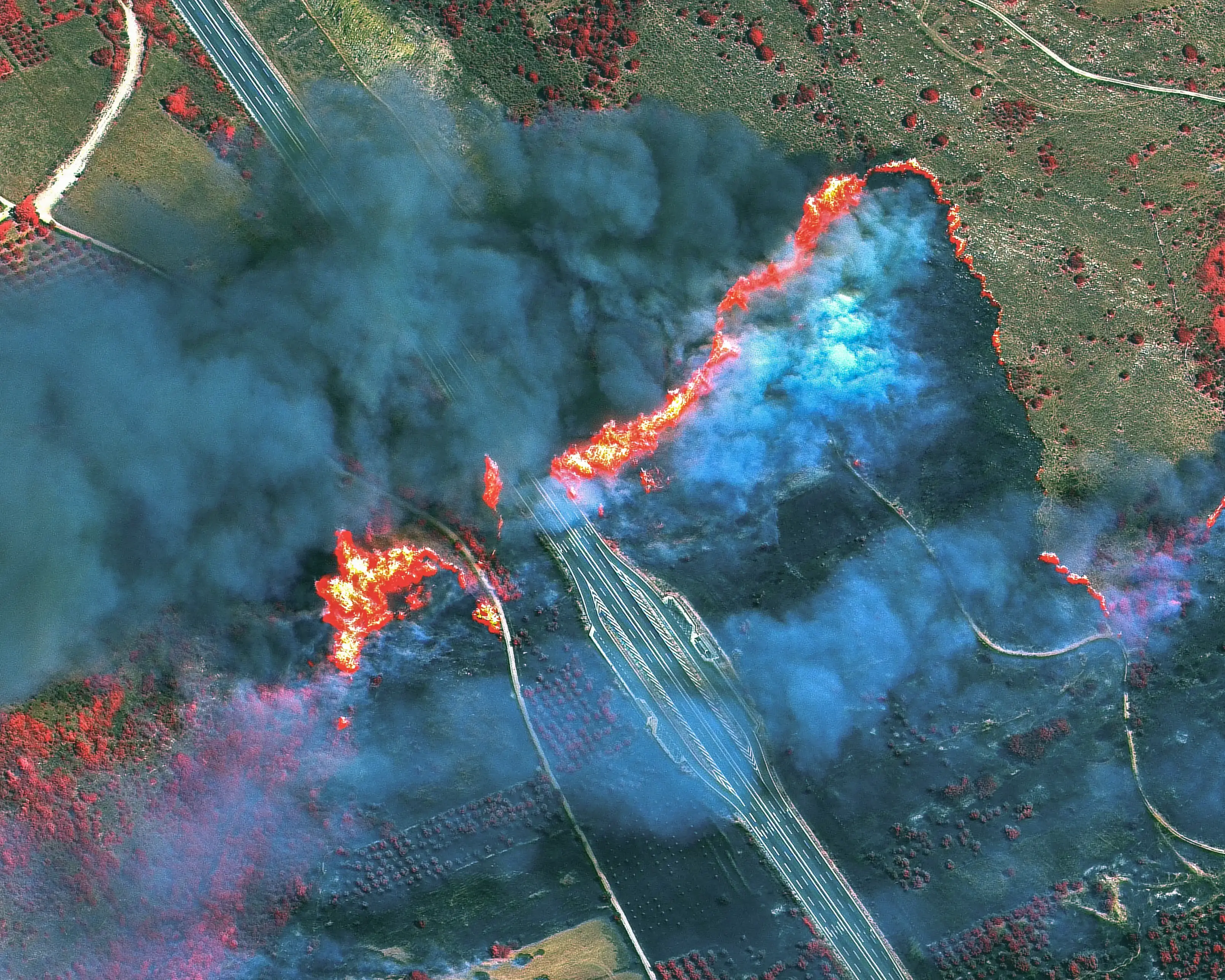 Smoke and flames as wildfires cross the highway in Gymnotopos, in the Epirus region of Greece. Smoke and flames as wildfires cross the highway in Gymnotopos, in the Epirus region of Greece.