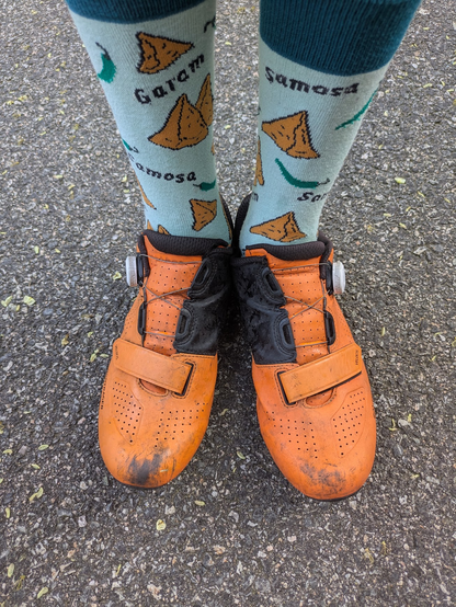 Socks with samosa pictures on them and text reading "Garam samosa".