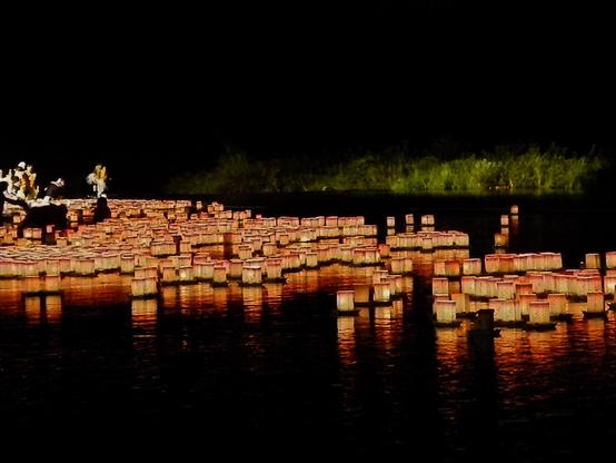 Lanterns being released on a river.