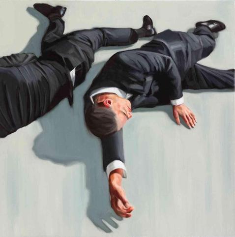 Two men in dark suits lie sprawled on a light gray surface, their bodies creating long shadows.