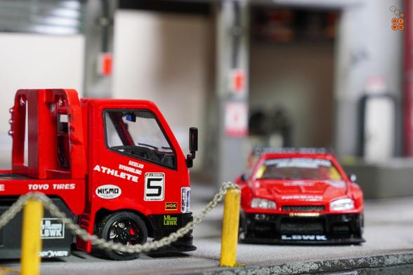 A Nissan Skyline LB-ER34 Super Silhouette by Mini GT and a Custom Tow Truck, LB Super Silhouette by Micro Turbo in 1:64 scale on AREA 164