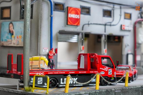 A Nissan Skyline LB-ER34 Super Silhouette by Mini GT and a Custom Tow Truck, LB Super Silhouette by Micro Turbo in 1:64 scale on AREA 164