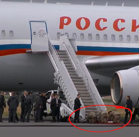 US soldiers on their knees and rolling out the red carpet for Putin