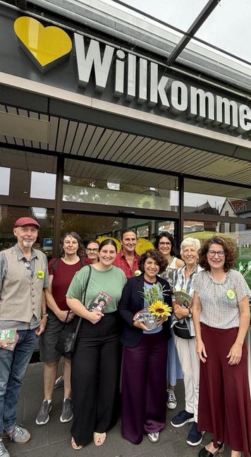 7 Porzer Grüne mit Zeybeck und Aymaz vor Stand an einem Supermarkt
