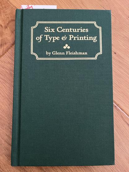The cover of Six Centuries of Type & Printing, by Glenn Fleishman - beautifully emerald green cloth bound hardback book with gold embossed lettering