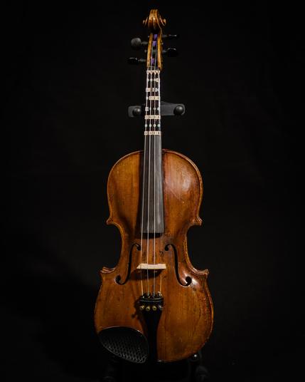An old violin on a black background.