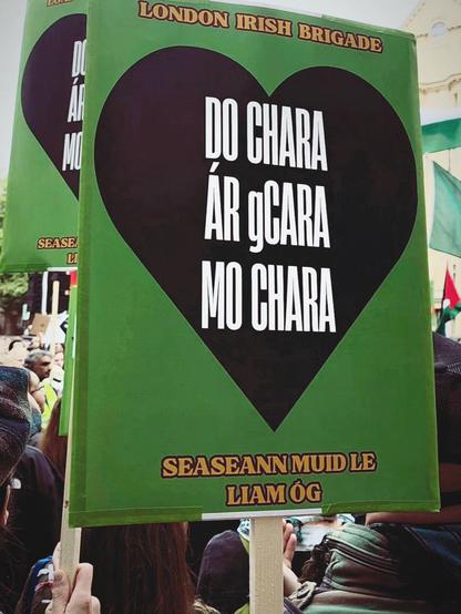 Sign that says "do chara, àr gcara, mo chara
