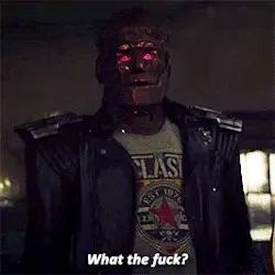Robotman (a reddish metallic crude robot wearing a leather jacket over a clash T-shirt ) from “doom patrol” with the caption “what the fuck?”