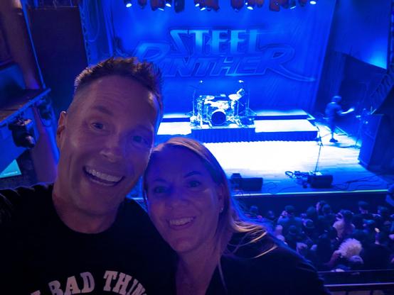 Two people in front of a stage 