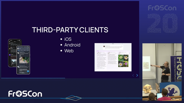 Presentation slide titled "THIRD-PARTY CLIENTS" listing iOS, Android, and Web, with images of mobile apps (Ivory and Tusky) and a web interface (Phanpy). A person is pointing at the screen during a talk at FrOSCon 20 conference.