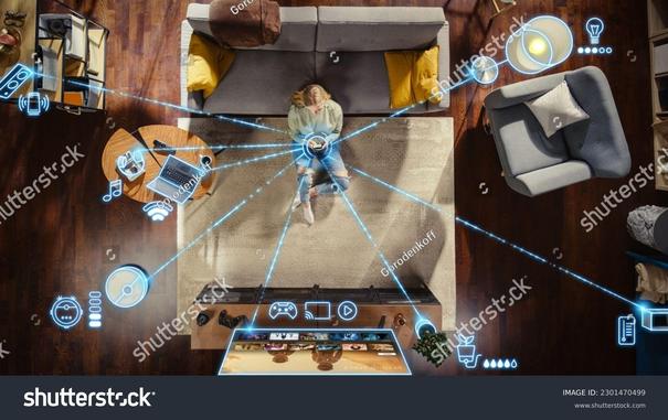 "Futuristic smart home concept showing a digital hand holding connected devices and glowing technology icons."