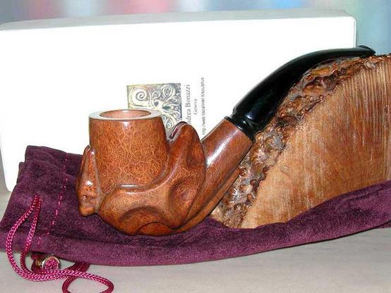 A dragon shaped briar tobacco pipe.