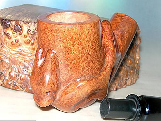 A dragon shaped briar tobacco pipe.
