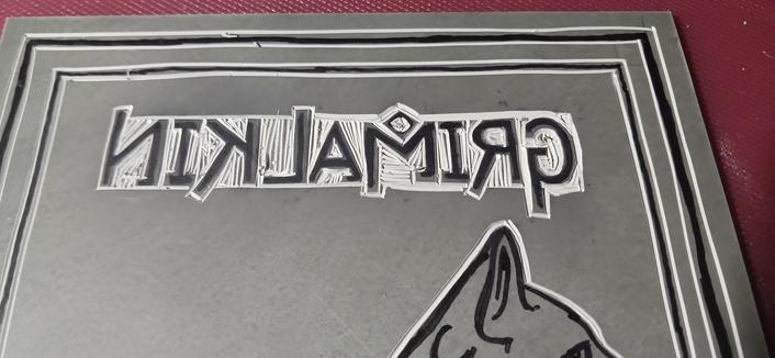 Image of my Grimalkin cat being cut into lino. The process is still unfinished. These photos show the overall design, the close up of the cat, still only outlined, and the text basically cut out in detail.