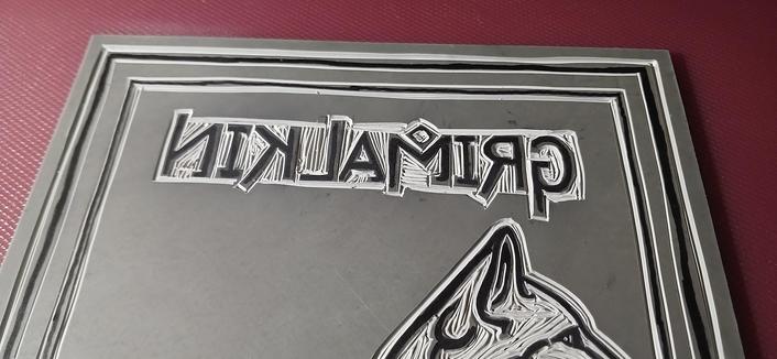 Image 2 of 3: A closeup of the text "Grimalkin" carved into lino.