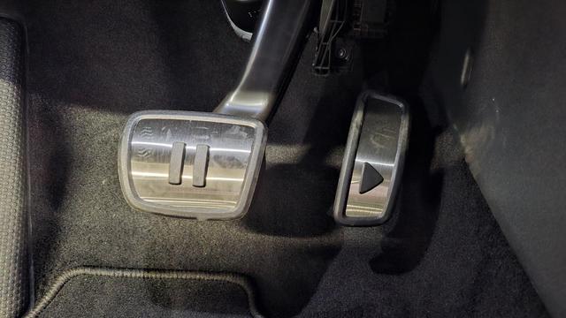 Car peddles, with a 'play' symbol on the gas and a 'pause' symbol on the break