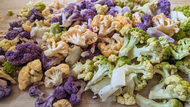 A medley cauliflower in a spectrum of people, gold and green.