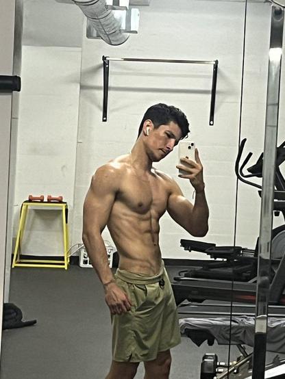 Photo of actor Danny Ramirez with his shirt off after working out.