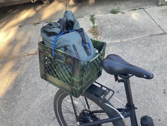 A milk crate on a rear bike rack.
