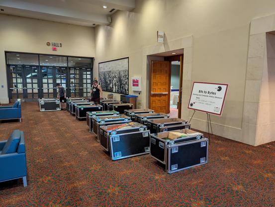 A group of open storage containers in a hallway as volunteers work to set up the museum