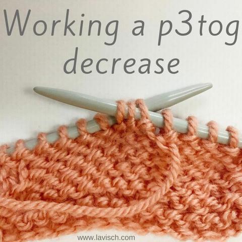 A swatch in salmon pink yarn on gray knitting needles, in which the p3tog decrease is being worked.
