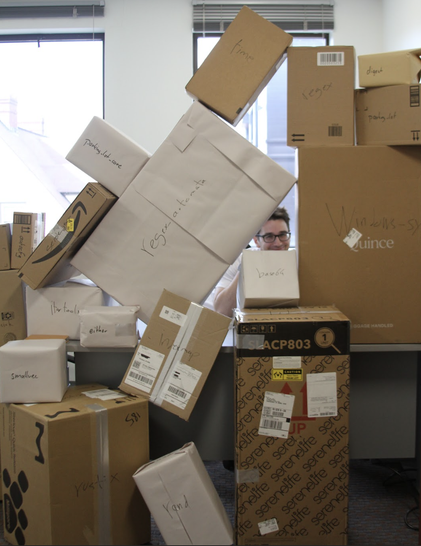 Lots of cardboard boxes, with names of popular Rust crates written on them.
