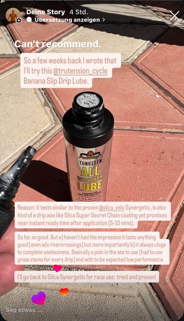 Image features a bottle of "Banana Slip Drip Lube" from @trutension_cycle, partially open with some lubricant visible. The background shows a patterned pavement. Overlaid text expresses a negative review of the product, comparing it to another.