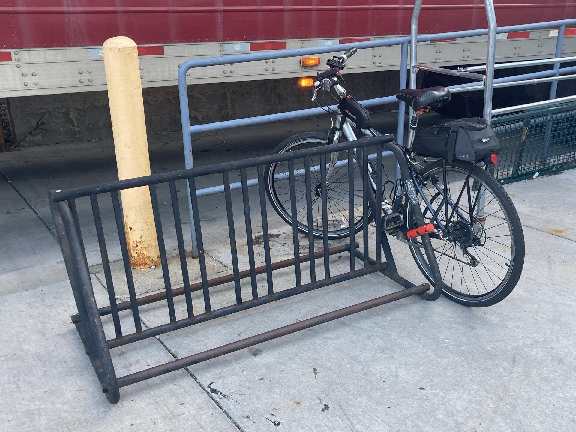 A bike locked up to a bike rack.