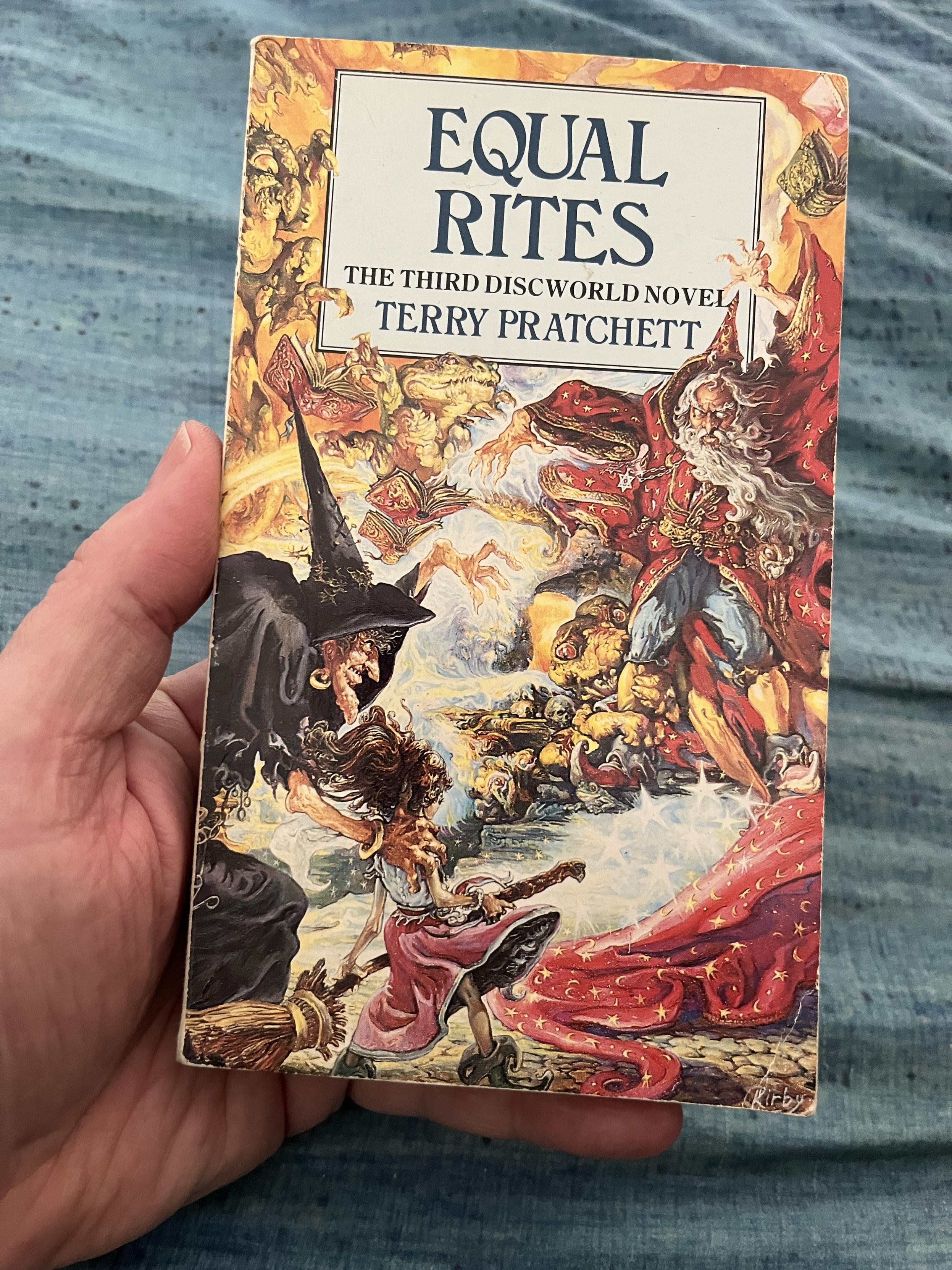 My original paperback copy of 'Equal Rites' ("The third Discworld novel", the cover also notes) by Terry Pratchett. The cover paining by Josh Kirby has a bright "humorous fantasy" style image of Granny Weatherwax with Eskarina Smith alongside, facing off in a magical duel with Archchancellor Cutangle.