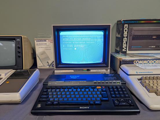 A Sony msx2+ and commodore monitor displaying a guestbook application