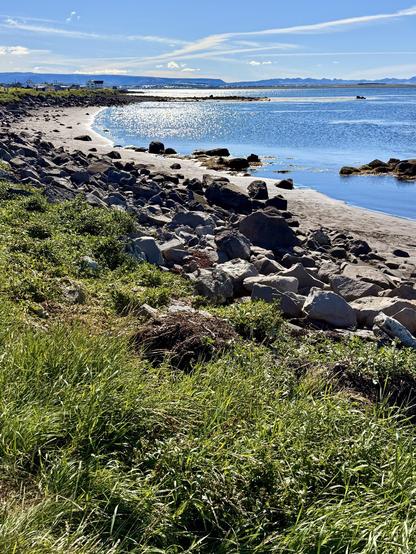Stones on a beach with beautiful blue waters and skies