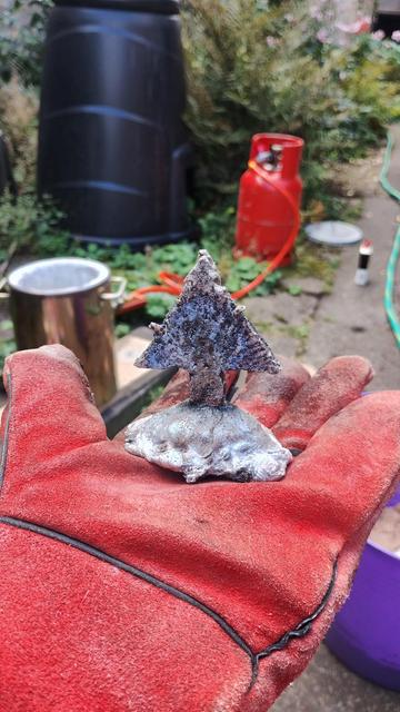 Some aluminium, melted down from cans, cast into a crude pointy shape.