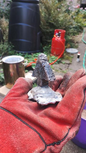 Some aluminium, melted down from cans, cast into a crude pointy shape.