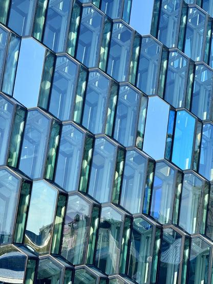 The repetitive windows of Harpa concert hall reflect the blue of the skies