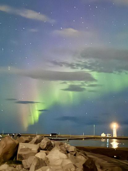 A line of aurora mixed with clouds can be seen over the Grótta light house outside Reykjavík 