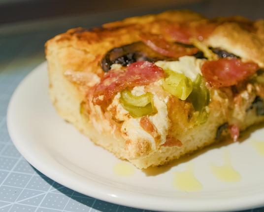 Focaccia pizza corner. Close-up of pepperoncini.