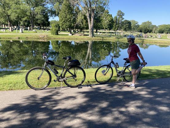 A person stretching near two bikes.