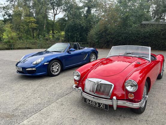 A red MGA 1600 and a blue Boxster 987.2