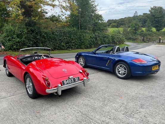 A red MGA 1600 and a blue Boxster 987.2