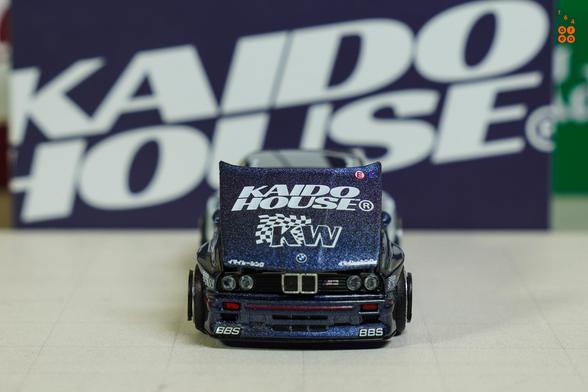 A front side of BMW M3 E30, Kaido Works V1 by Mini GT in 1:64 scale on AREA 164