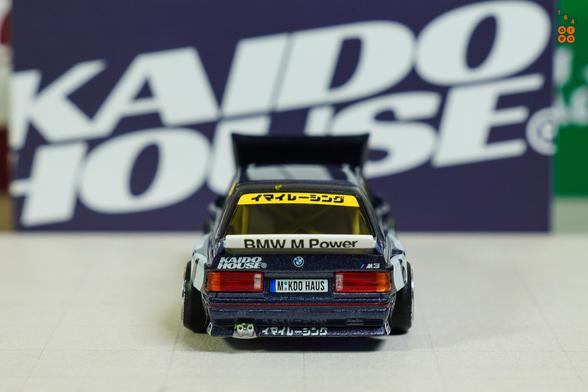 A rear side of BMW M3 E30, Kaido Works V1 by Mini GT in 1:64 scale on AREA 164