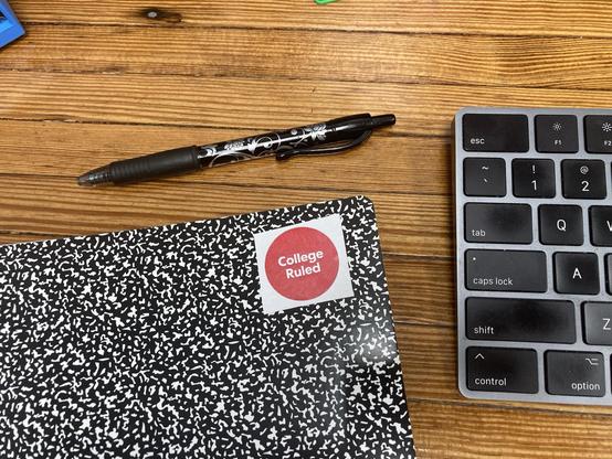 A notebook with a sticker that says "College Ruled".