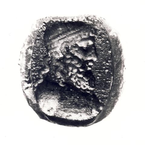 Glass cast of Zeus-Jupiter on a signet ring. The god is depicted as a mature man with a full beard and long hair. He's wearing a crown or fillet around his head. He is shown in profile.