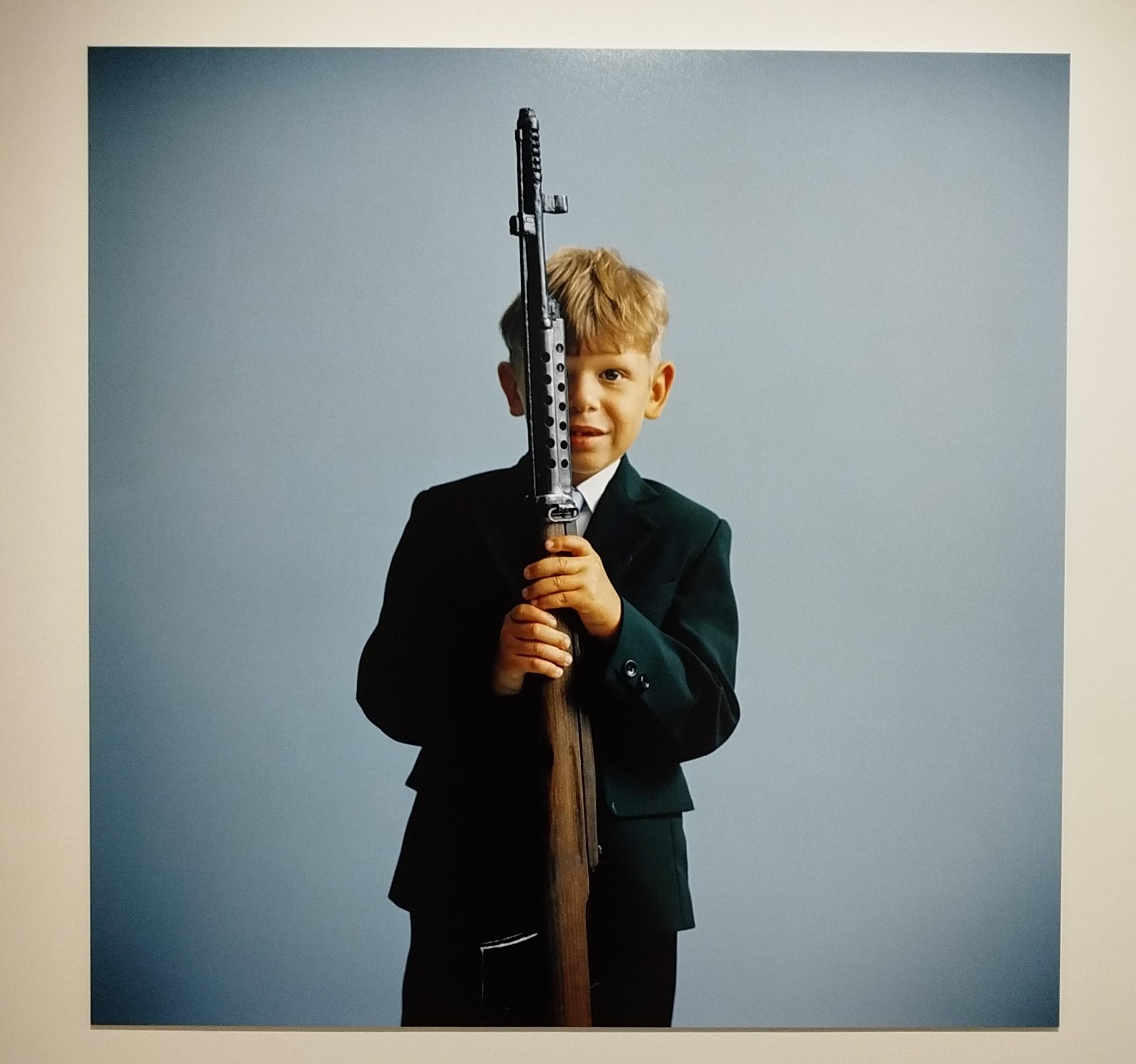 photographie de Roger Cremers datant de 2013. Elle décrit un élève du lycée de Khotiv (Ukraine) posant avec un fusil de collection après un cours d'histoire donné par un groupe de reconstitution historique.