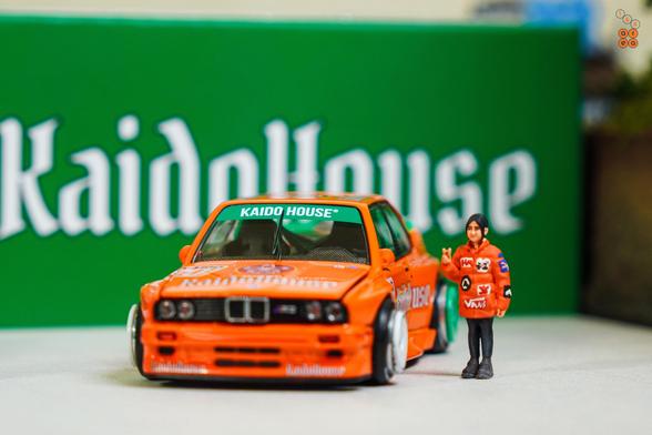 A BMW M3 E30, KaidoHaus V1 by Mini GT in 1:64 scale with 1:64 figure on AREA 164