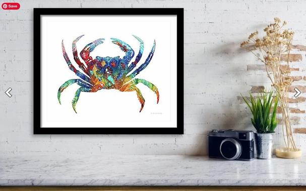 Colorful crab painting/collage on crisp white background in a furniture setting by artist Sharon Cummings.